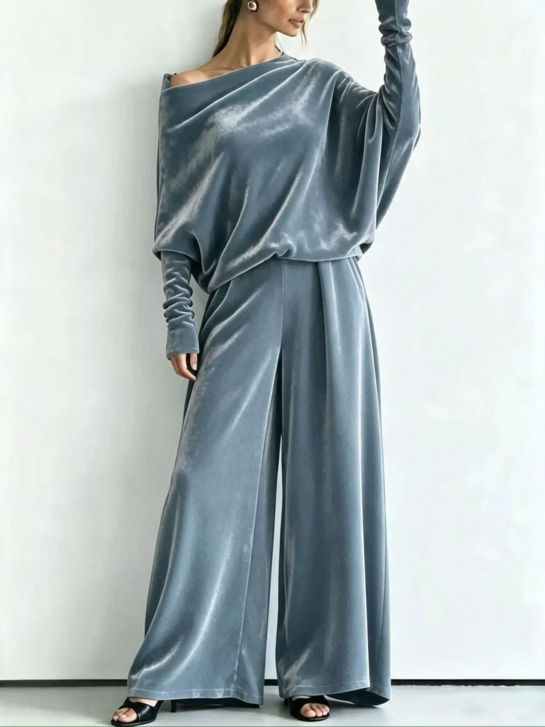 Woman wearing light blue velvet off-shoulder top and wide leg pants set