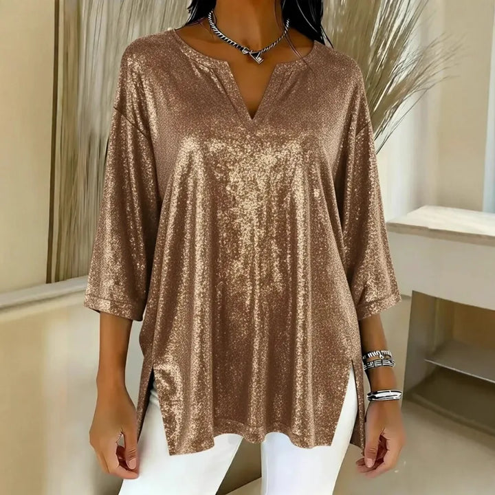Woman wearing gold shimmer oversized blouse with V-neck