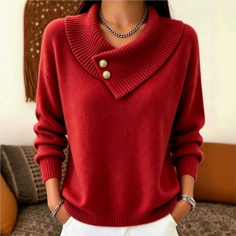 Woman wearing red sweater with asymmetric ribbed collar and gold buttons