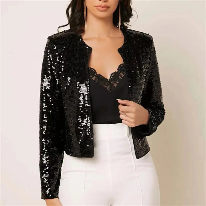 Woman wearing black sequin jacket over black lace top