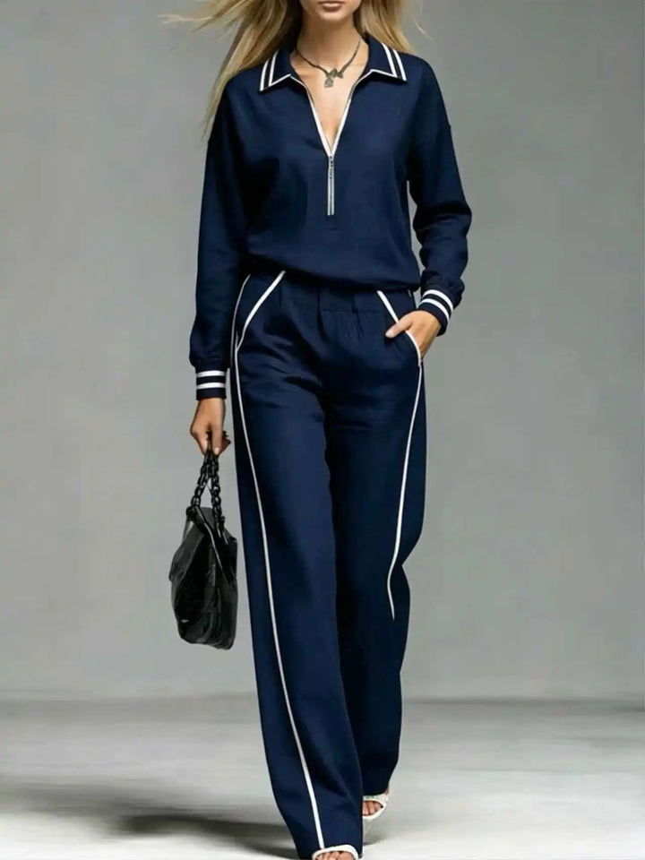 Woman wearing deep blue half-zip two piece pant set close up