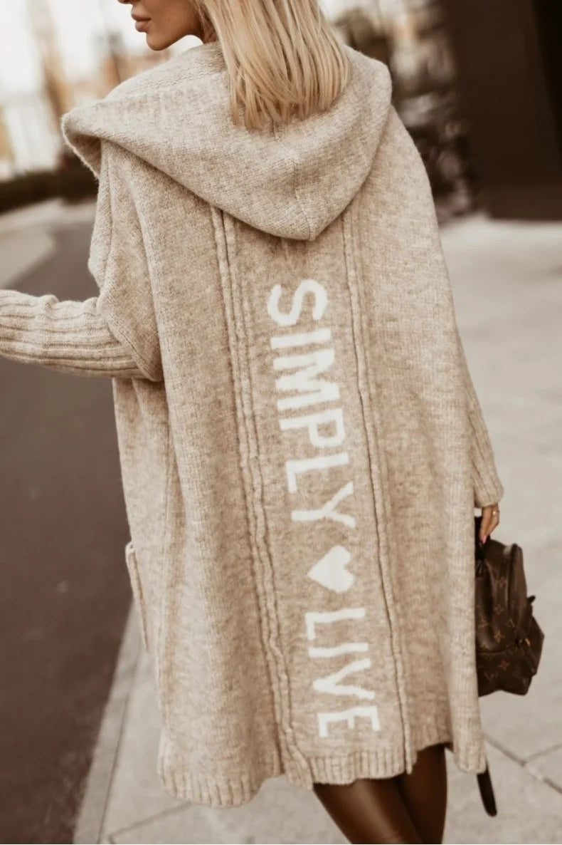 Back view of camel hooded cardigan with knit lettering graphic