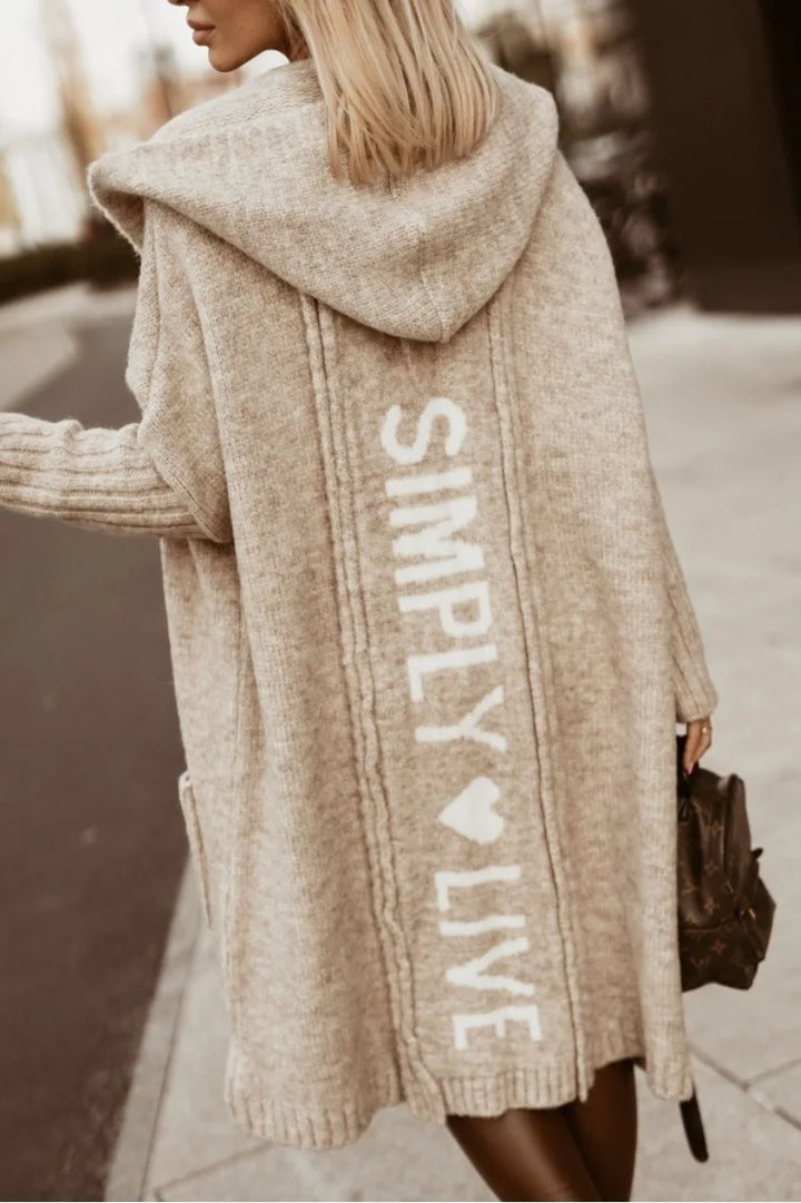 Back view of camel hooded cardigan with knit lettering graphic