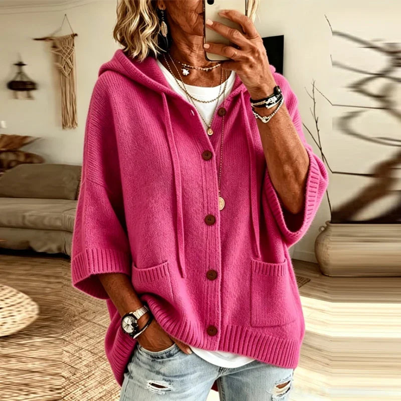 Woman wearing hot pink hooded button-front cardigan