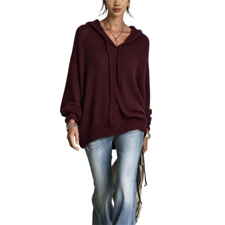 Woman wearing burgundy hooded knit sweater with drawstring neckline