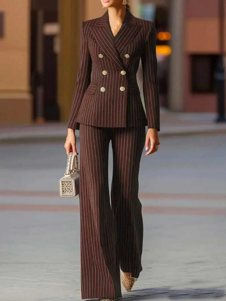 Woman wearing brown pinstripe double-breasted pant suit walking outdoors
