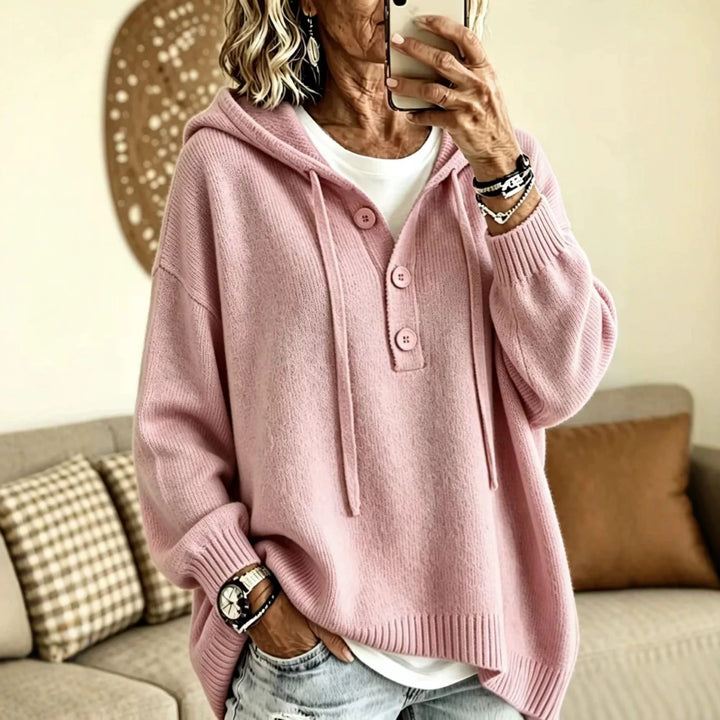 Woman wearing pink ribbed knit hoodie with drawstring hood
