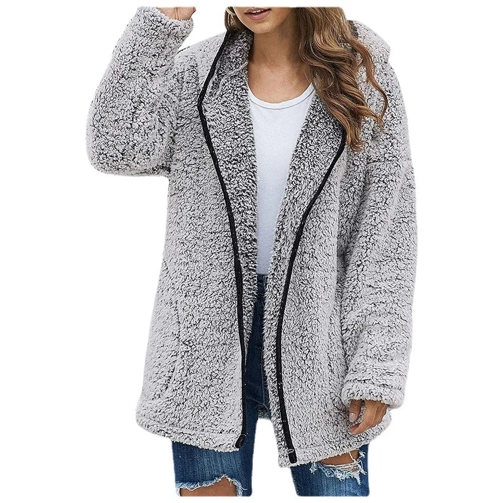 Woman wearing light gray brushed sherpa hooded jacket with black trim