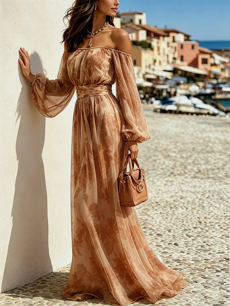 Woman wearing brown floral print off-shoulder maxi dress, side view