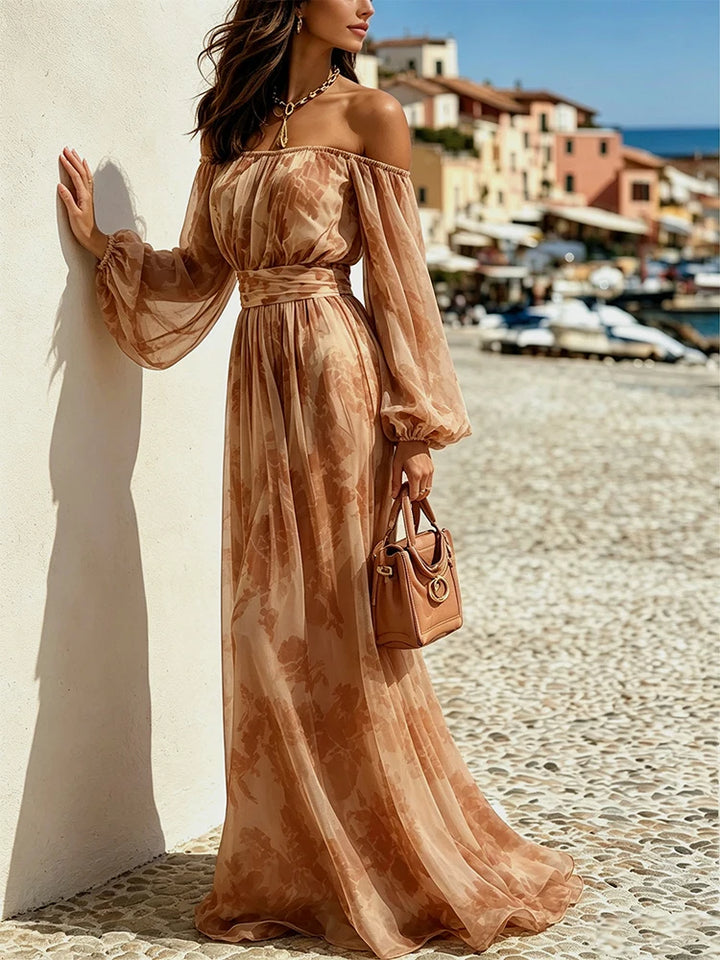 Woman wearing brown floral print off-shoulder maxi dress, side view