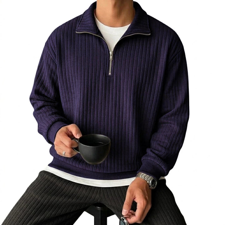Man wearing navy ribbed quarter-zip pullover, front view