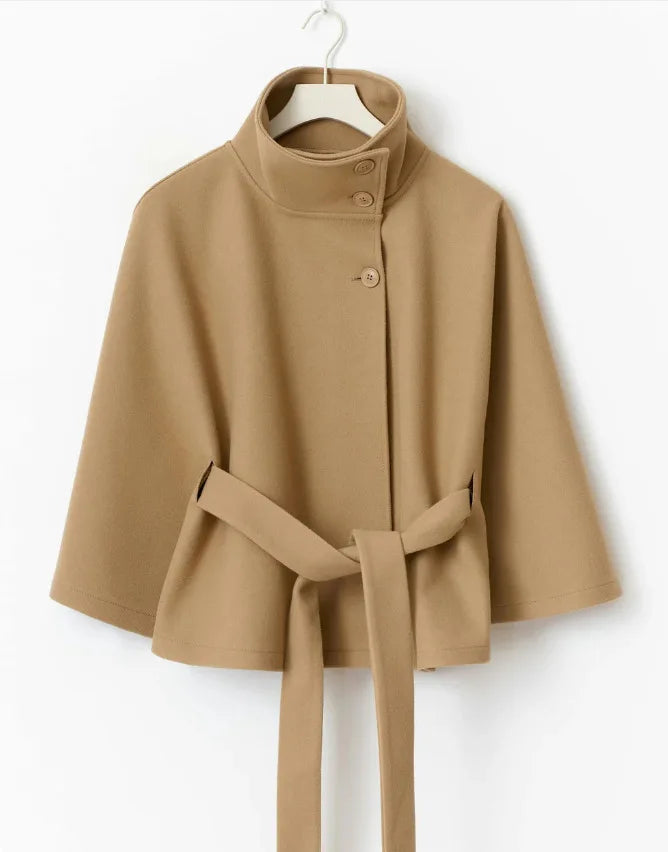 Camel cape jacket on hanger with belted waist and stand collar