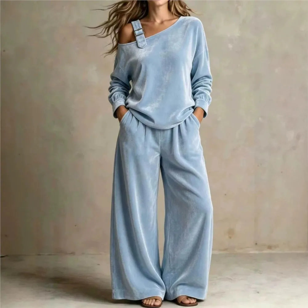 Woman wearing light blue velvet off shoulder top and wide leg pants set