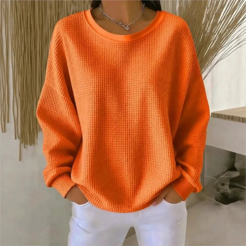 Woman wearing orange waffle knit oversized top