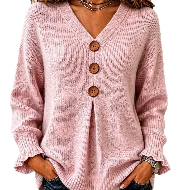 Close up of pink ribbed knit sweater button placket and V-neck