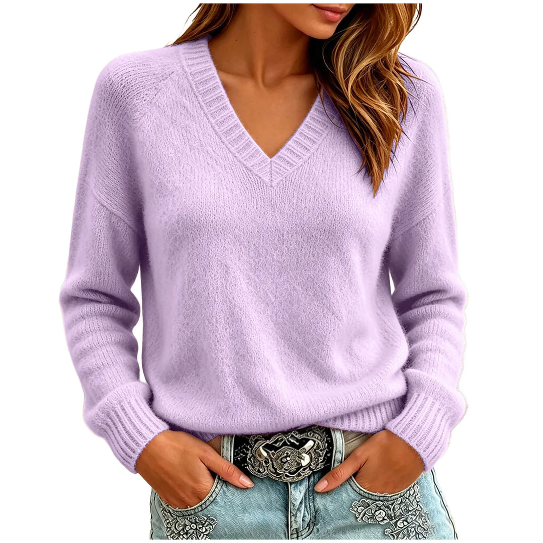 Woman wearing purple oversized V-neck knit sweater with hands in pockets