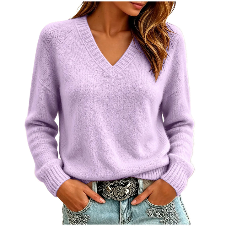 Woman wearing purple oversized V-neck knit sweater with hands in pockets