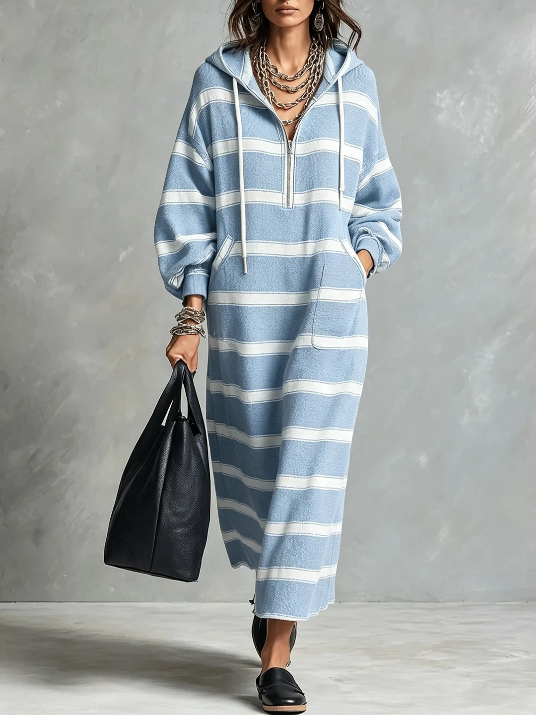 Woman walking in light blue and white striped half-zip hoodie maxi dress