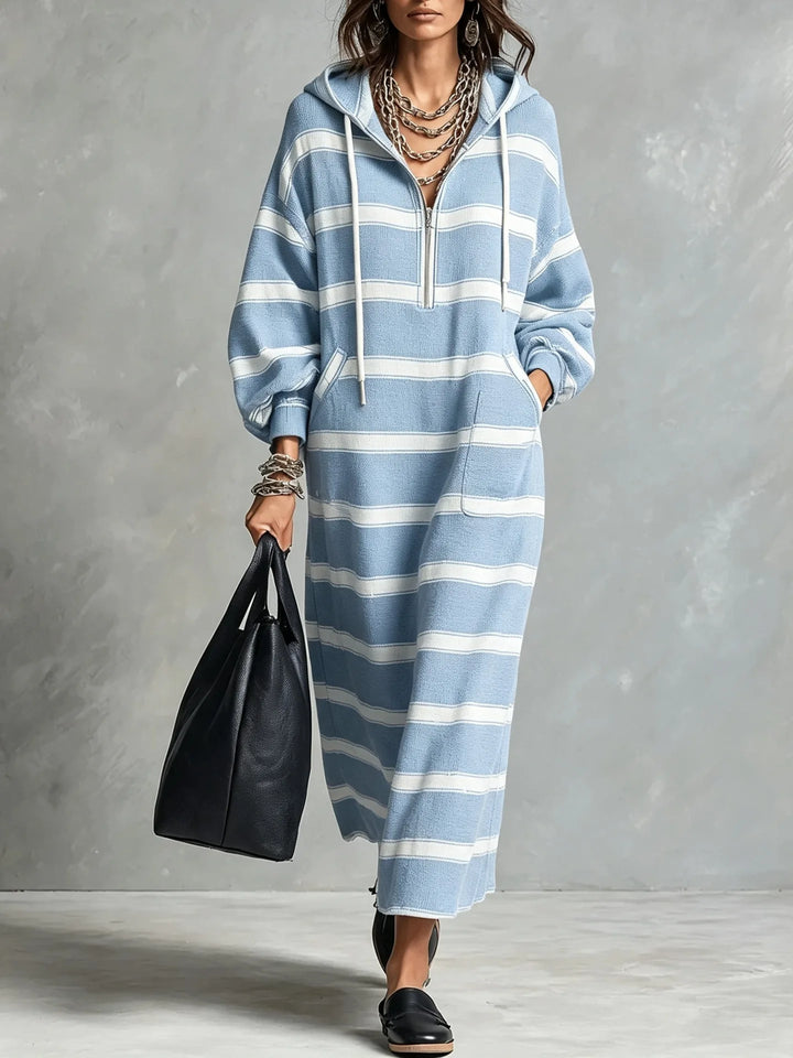 Woman walking in light blue and white striped half-zip hoodie maxi dress