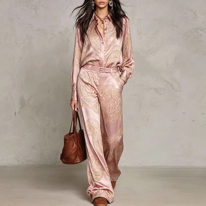 Woman wearing pink paisley print two-piece shirt and wide leg pants set with belt