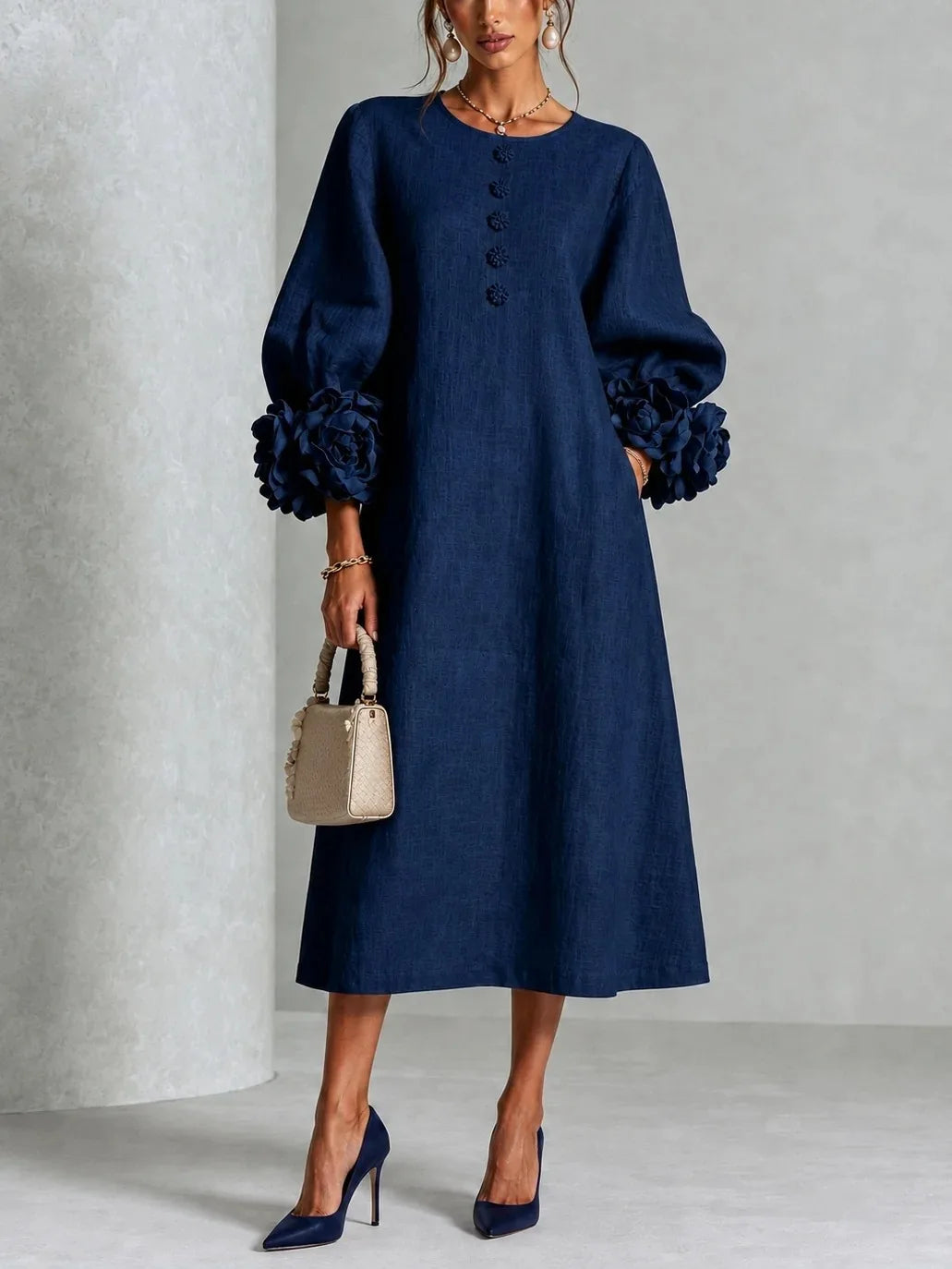 Woman wearing navy blue midi dress with 3D floral lantern sleeve cuffs