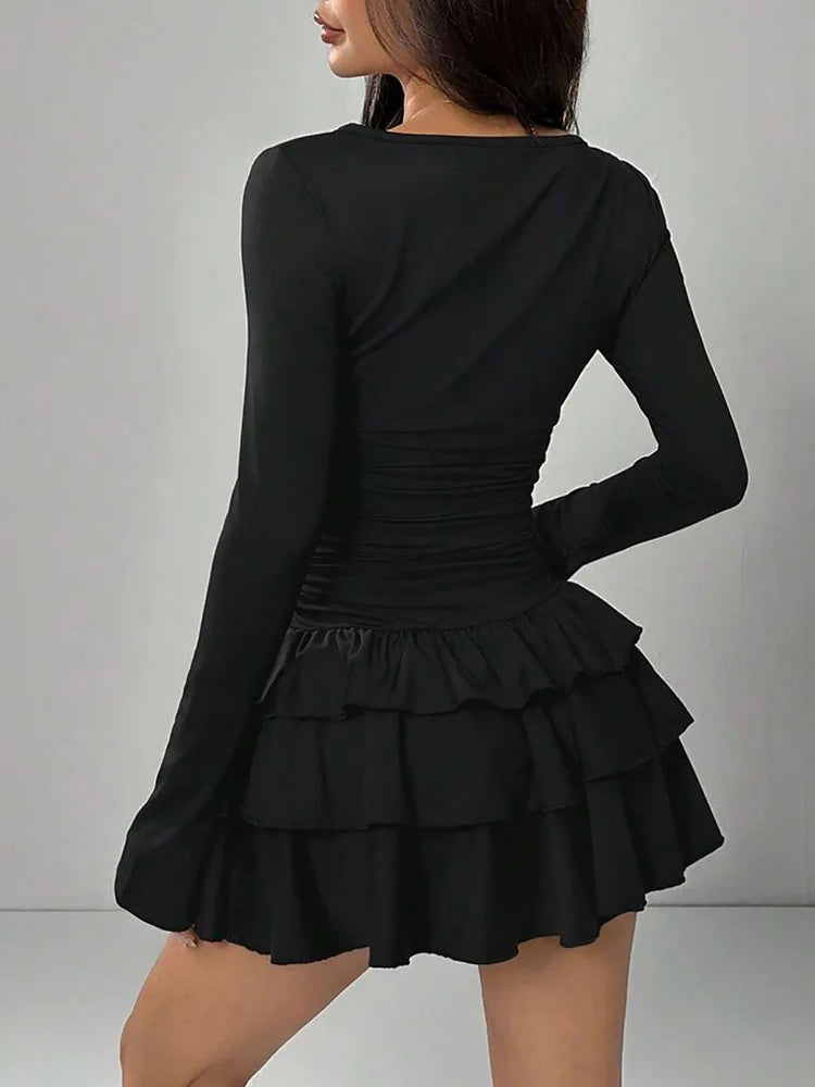 Black tiered ruffle mini dress, back view