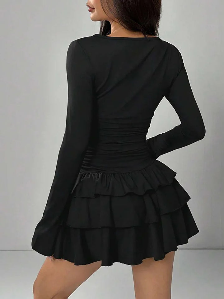 Black tiered ruffle mini dress, back view