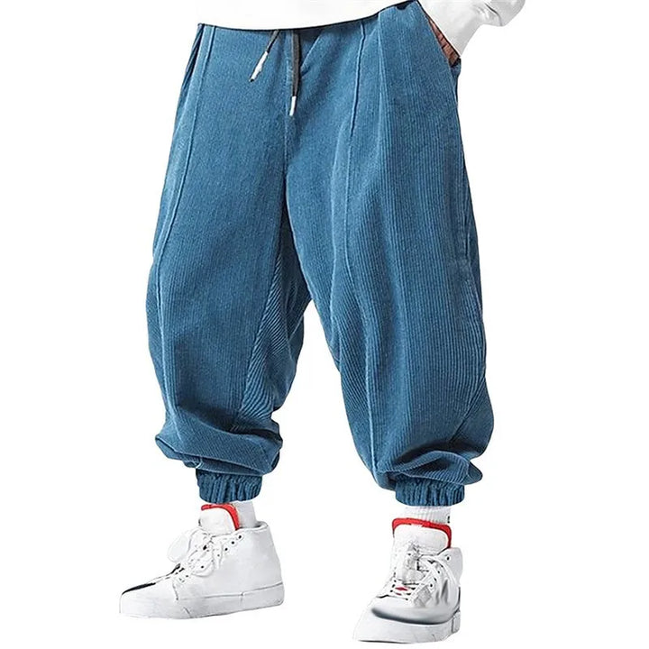 Man wearing sky blue corduroy jogger pants with drawstring waist