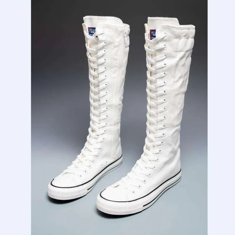White knee-high lace-up canvas boots, front angled view