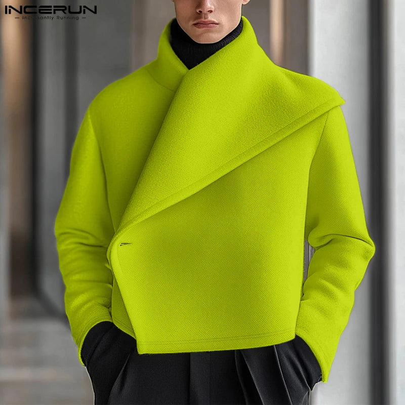 Man wearing green asymmetric shawl collar cropped jacket, front view