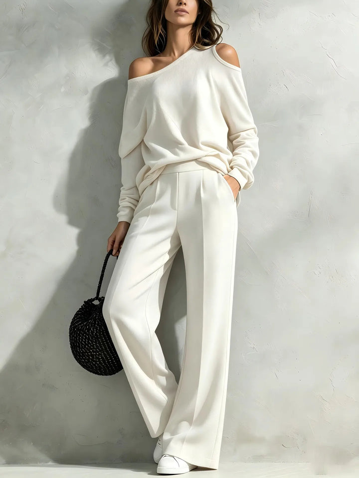 Woman wearing white off shoulder top and wide leg pants set