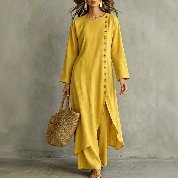 Woman wearing yellow two piece set with asymmetric button placket top and wide leg pants