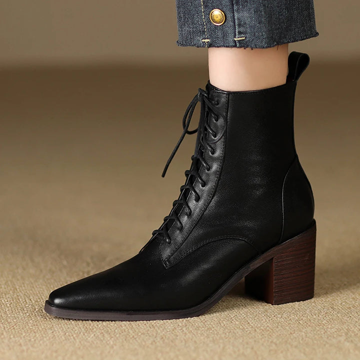 Black leather lace-up ankle boot side view on model