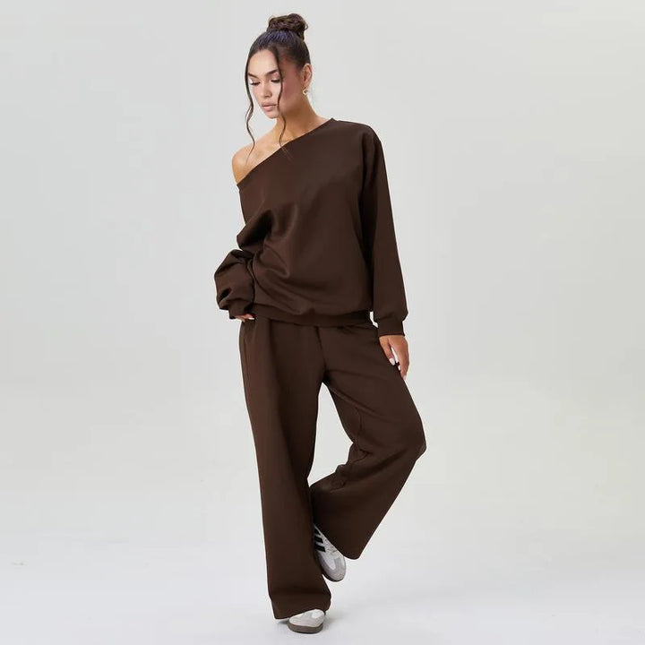 Woman wearing dark brown off-shoulder tracksuit set looking down