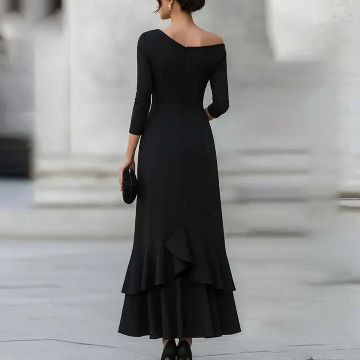 Black off-shoulder mermaid dress back view showing tiered ruffle hem