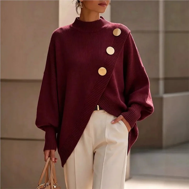 Woman wearing burgundy asymmetric hem sweater with gold buttons