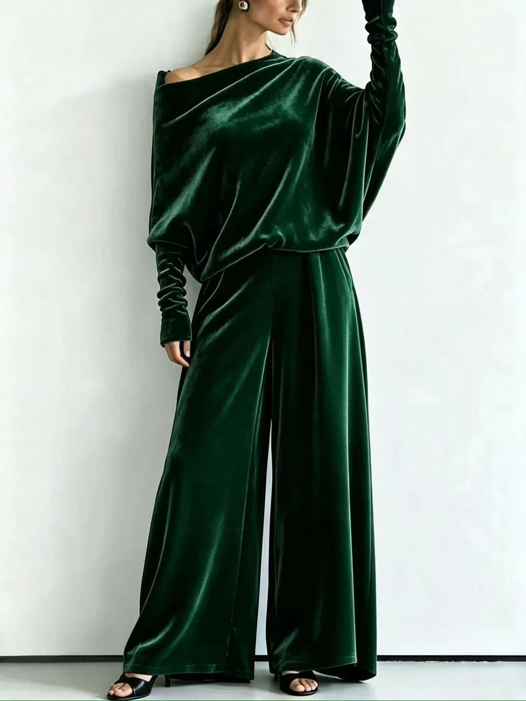 Woman wearing green velvet off-shoulder top and wide leg pants set