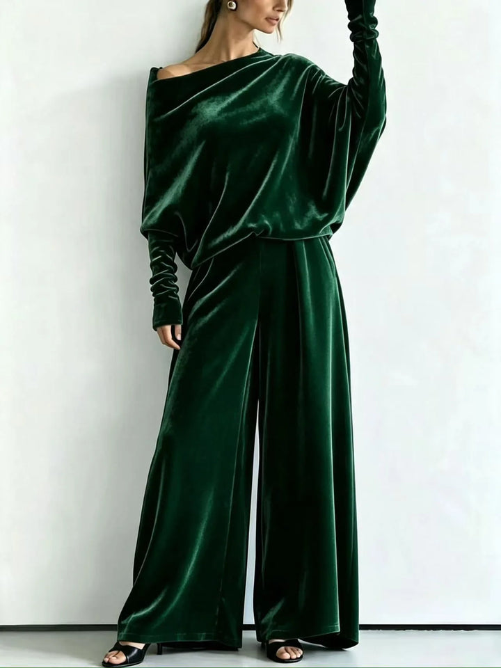 Woman wearing green velvet off-shoulder top and wide leg pants set