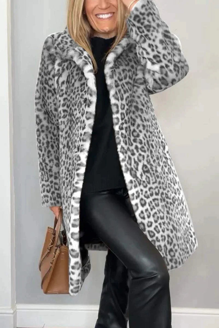 Model wearing long gray leopard print faux fur coat with handbag
