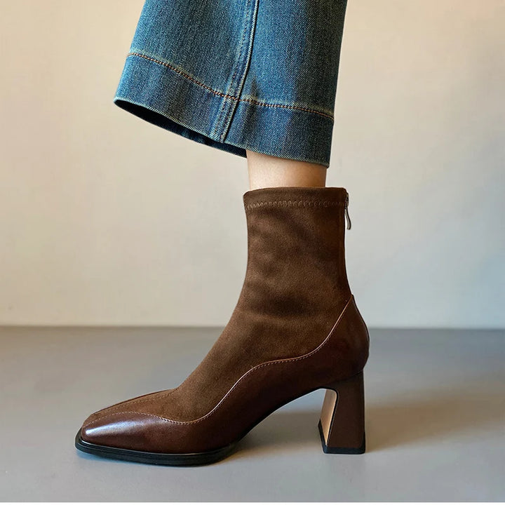Brown ankle boot side view showing zip and heel