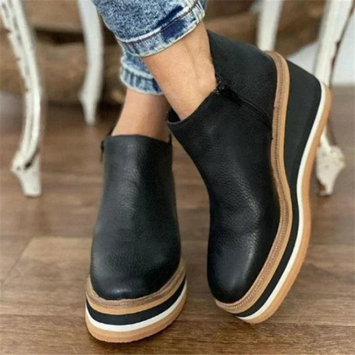 Black leather platform wedge ankle boots on model