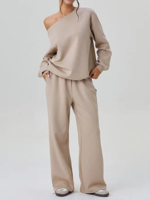 Woman wearing apricot off-shoulder sweatshirt and wide leg pants side view