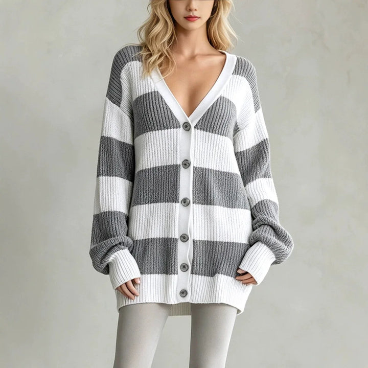Woman wearing grey and white striped oversized cardigan sweater