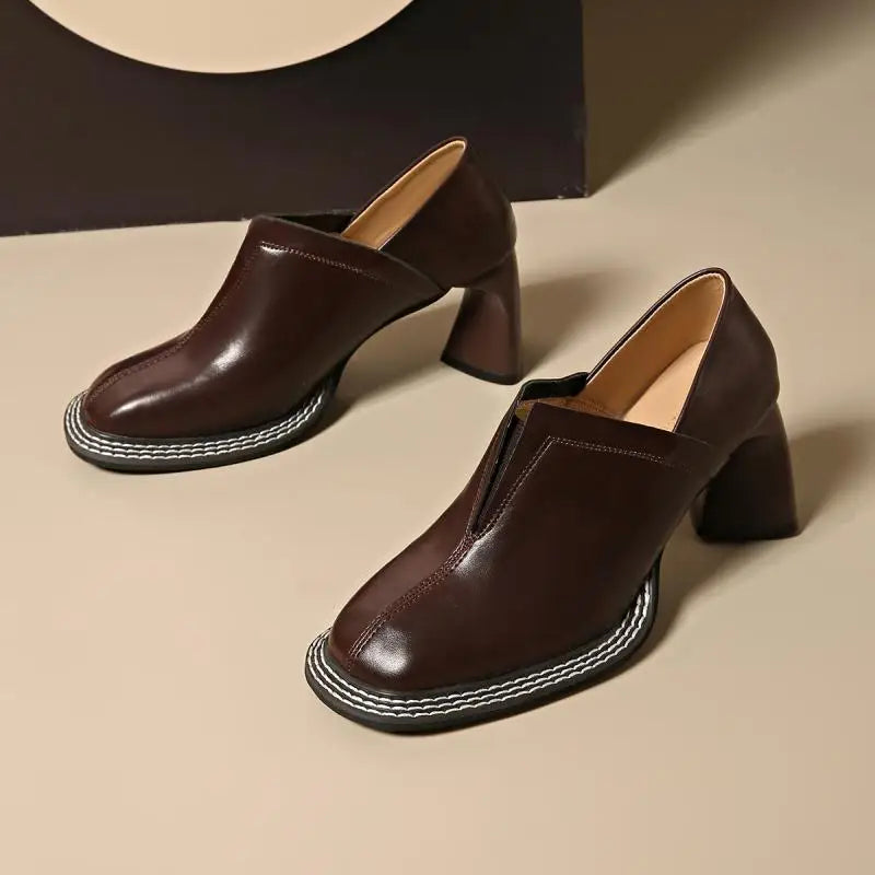 Pair of brown leather loafers with contrast stitched sole