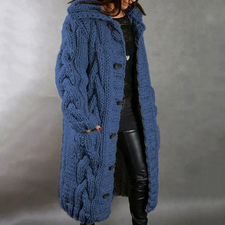 Woman wearing blue hooded cable knit long cardigan, side view