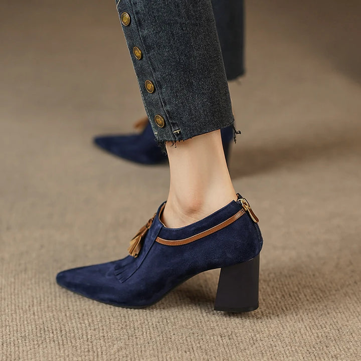 Rear view of model walking in navy suede pumps