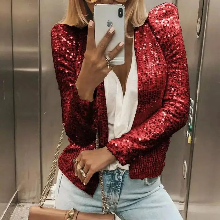 Woman wearing red sequin cropped jacket in elevator
