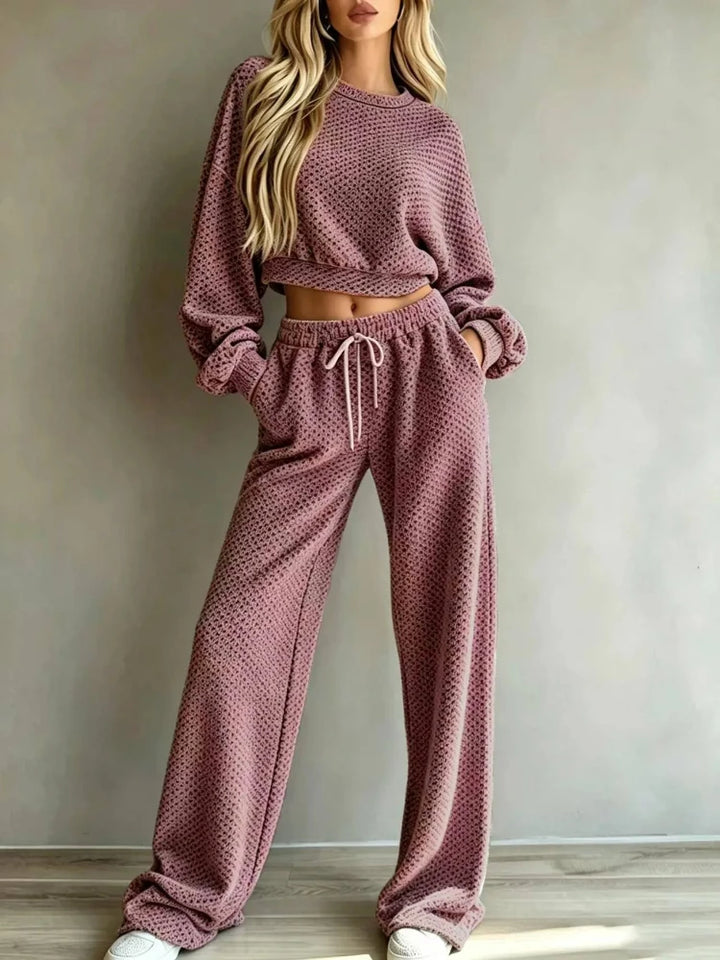 Woman wearing mauve pink textured knit cropped top and wide leg pants set