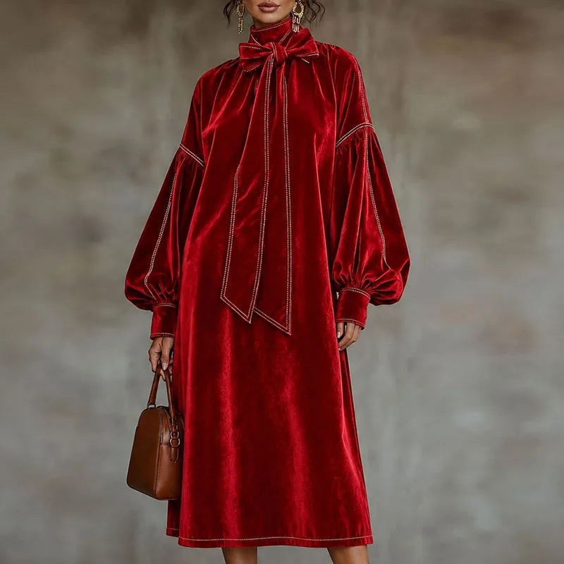 Woman wearing red velvet maxi dress with lantern sleeves