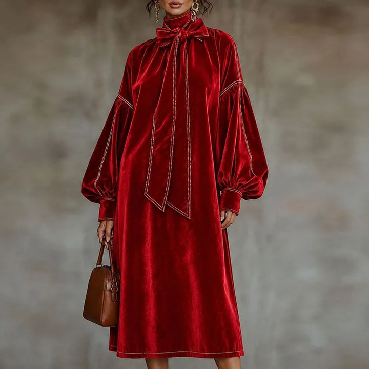 Woman wearing red velvet maxi dress with lantern sleeves